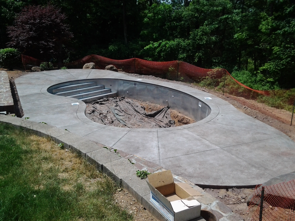 Swimming pool project with decorative concrete and shaped decking